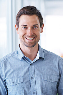 man in buttondown shirt smiling