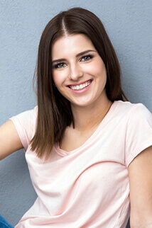 woman in pink smiling vibrantly