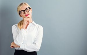 A woman pondering which dentist to choose.